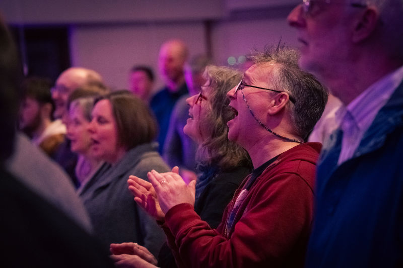Happy people worshipping in the church